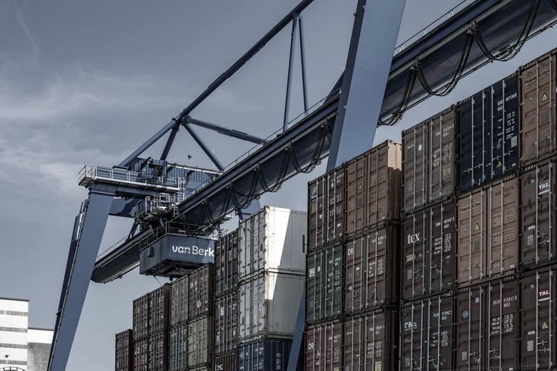 Shipping containers stacked at a quayside terminal